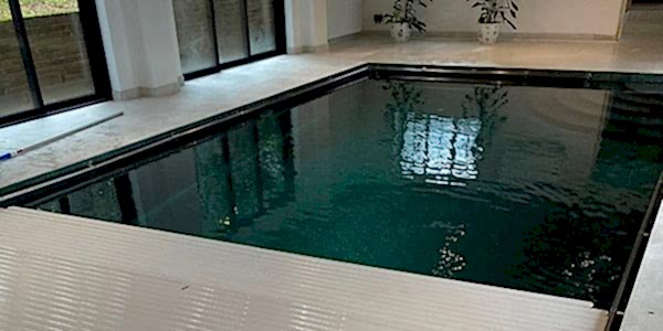 Indoor swimming pool with Automatic Swimming Pool Cover - by UK Swimming Pools Ltd