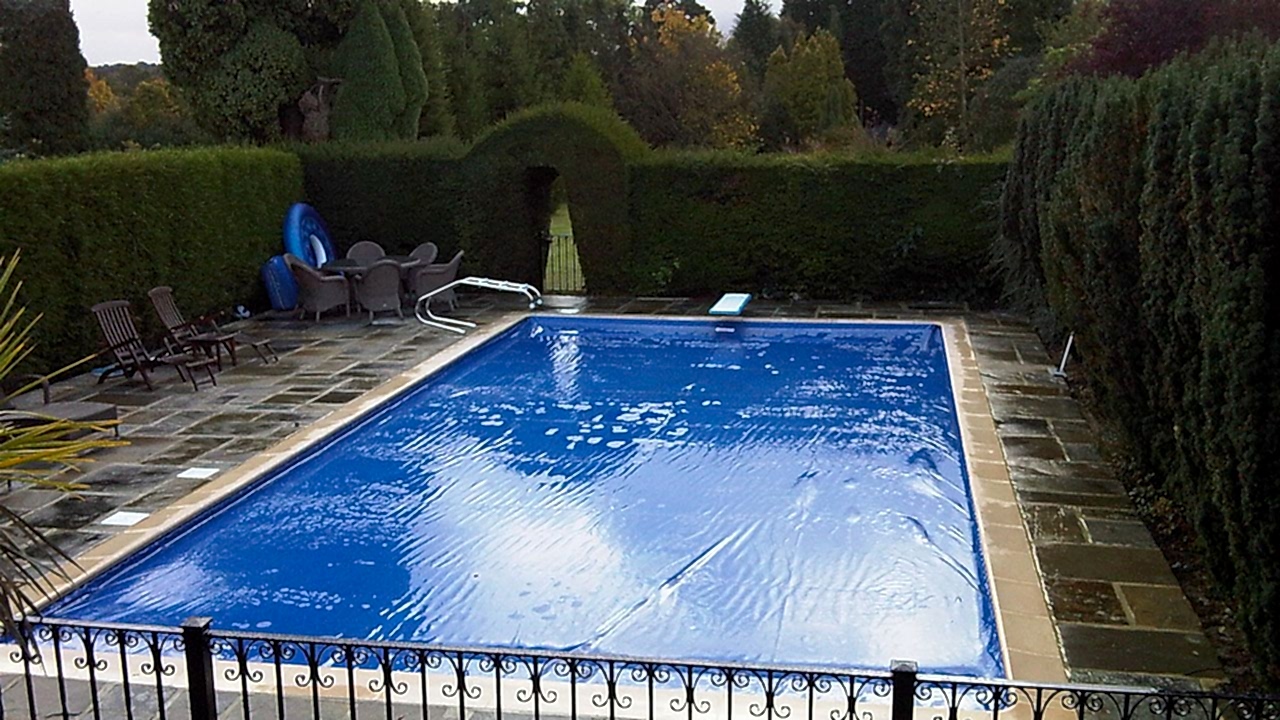 Automatic cover on an outdoor swimming pool – installed by UK Swimming Pools Ltd Automatic cover on an outdoor swimming pool - installed by UK Swimming Pools Ltd