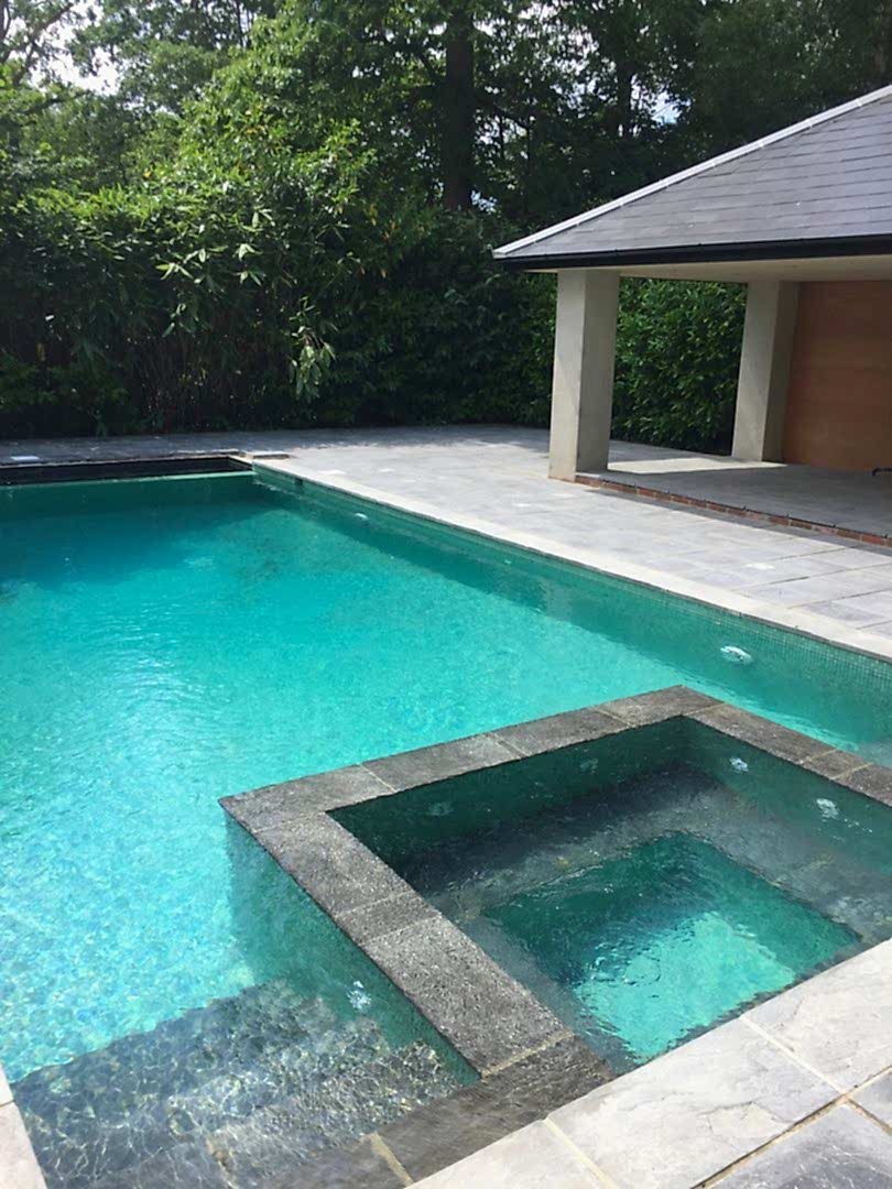 The elegantly designed pool and spa combination with the outdoor kitchen area The elegantly designed pool and spa combination with the outdoor kitchen area