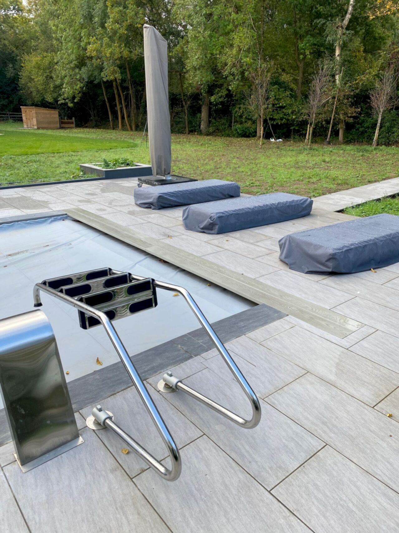 The steps are removed from the swimming pool while the pool cover is on