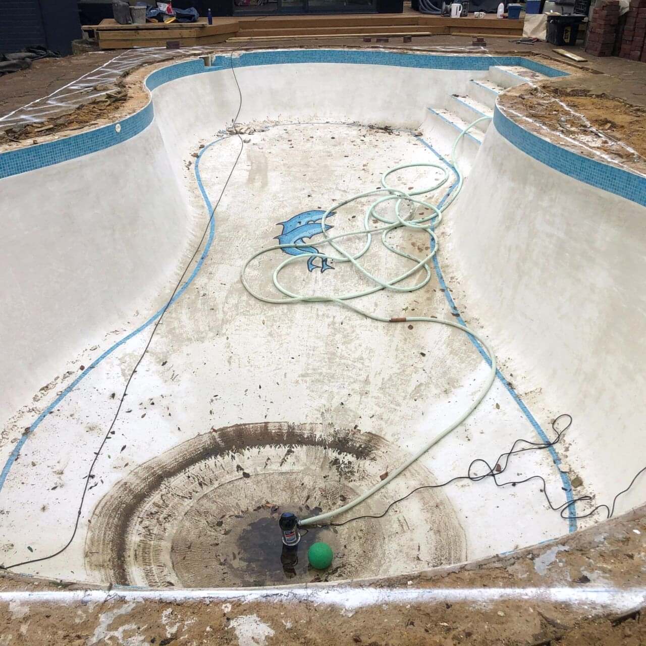 Water was drained and the new shape painted around the edges of the original kidney shaped pool