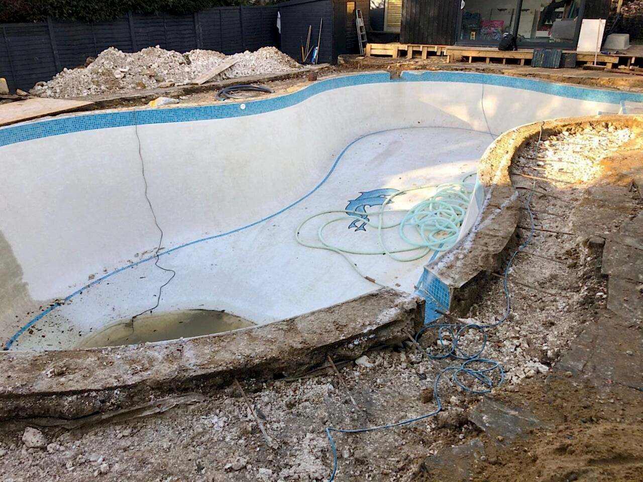 The reshaping work started by removing the original pavement around the pool