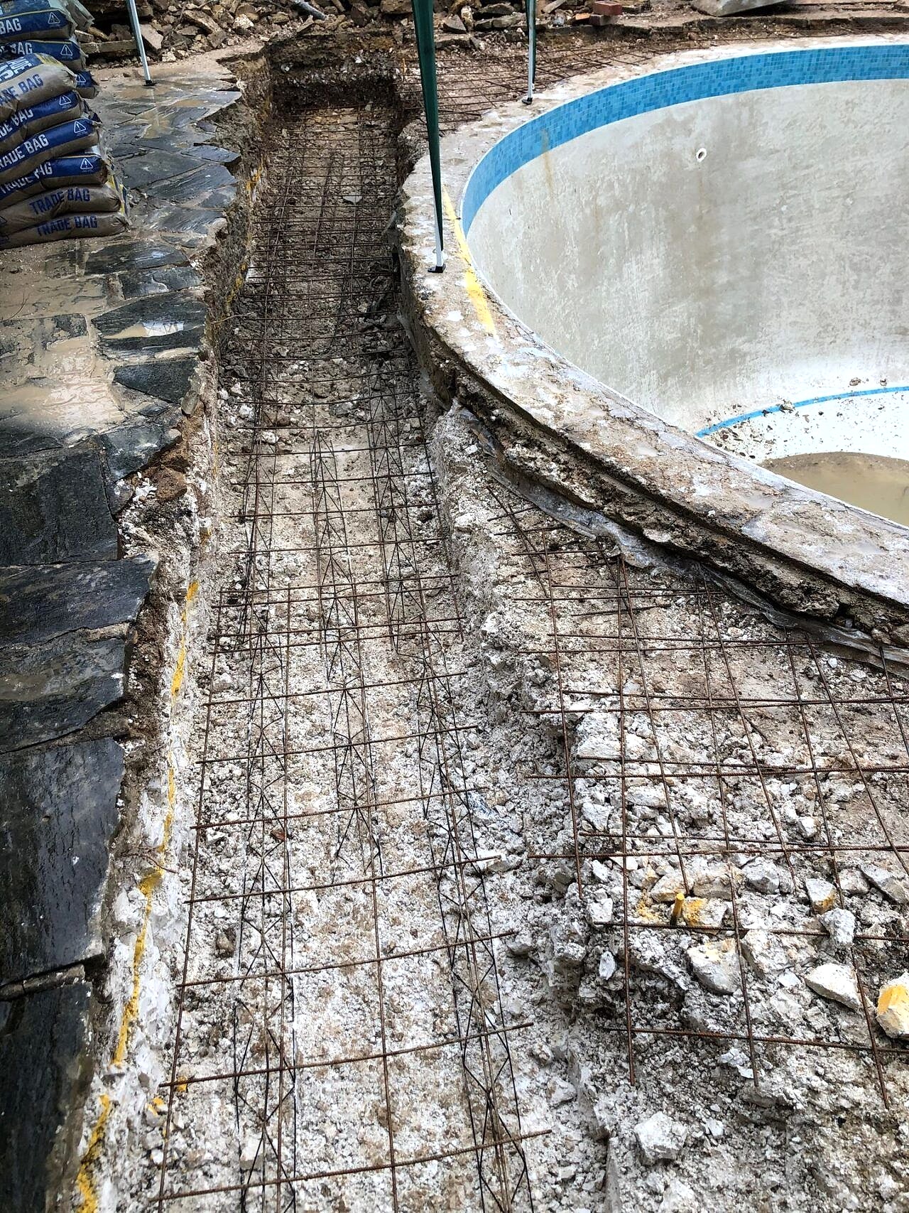 The reshaping work started by removing the original pavement around the pool
