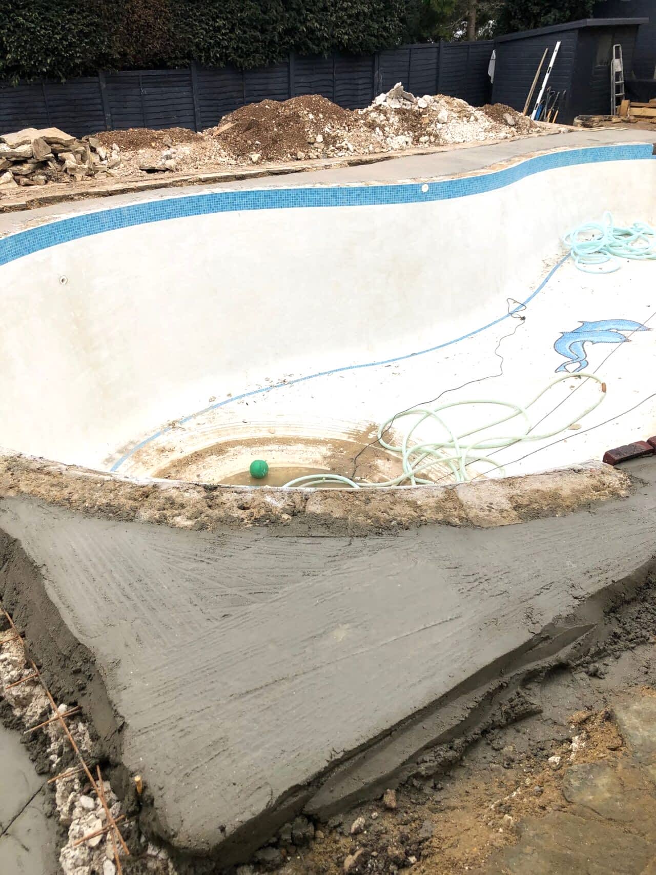 Concrete was applied around the pool for strength and stability