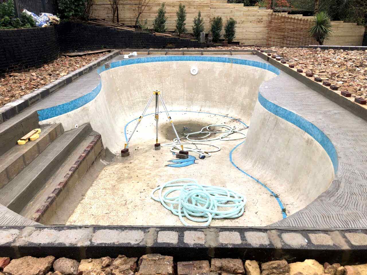 The original concrete pool was redesigned into a rectangular shape with integrated beach entries on two sides to facilitate supervised child access