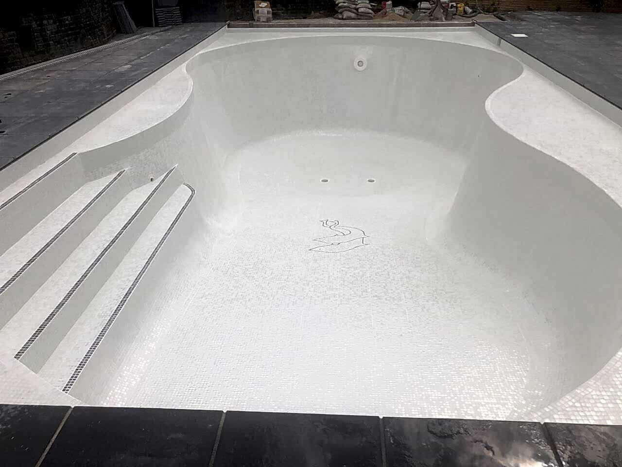 The entire pool interior was retiled with contemporary white glass mosaics and contrasting step demarcations