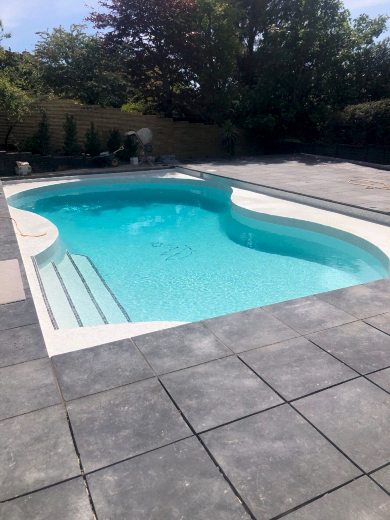 The surrounding pool deck was repaved according to the clients’ vision and screed wall finishes completed the renovation