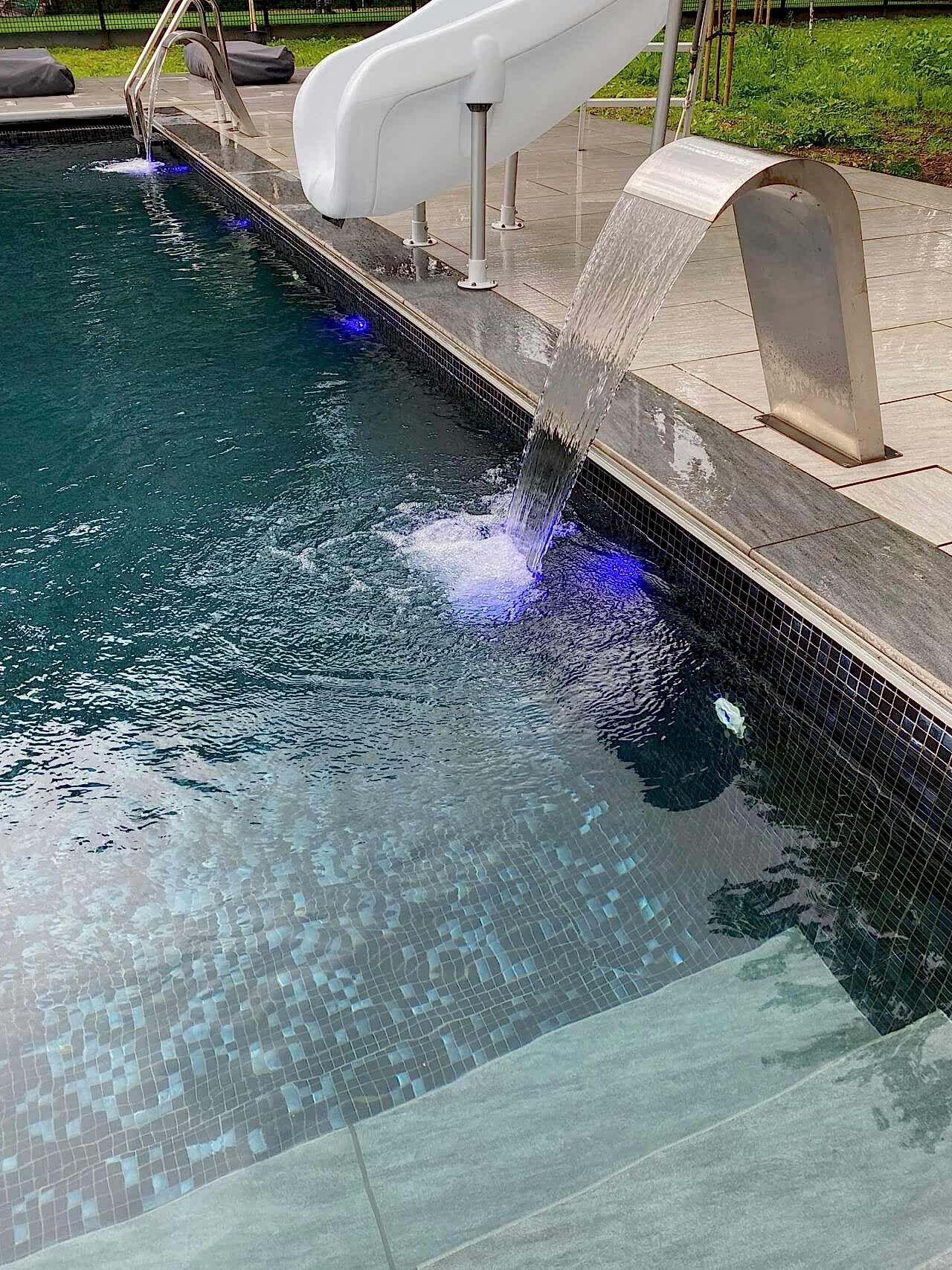 Close-up shot of the swimming pool and the elegant water fountains
