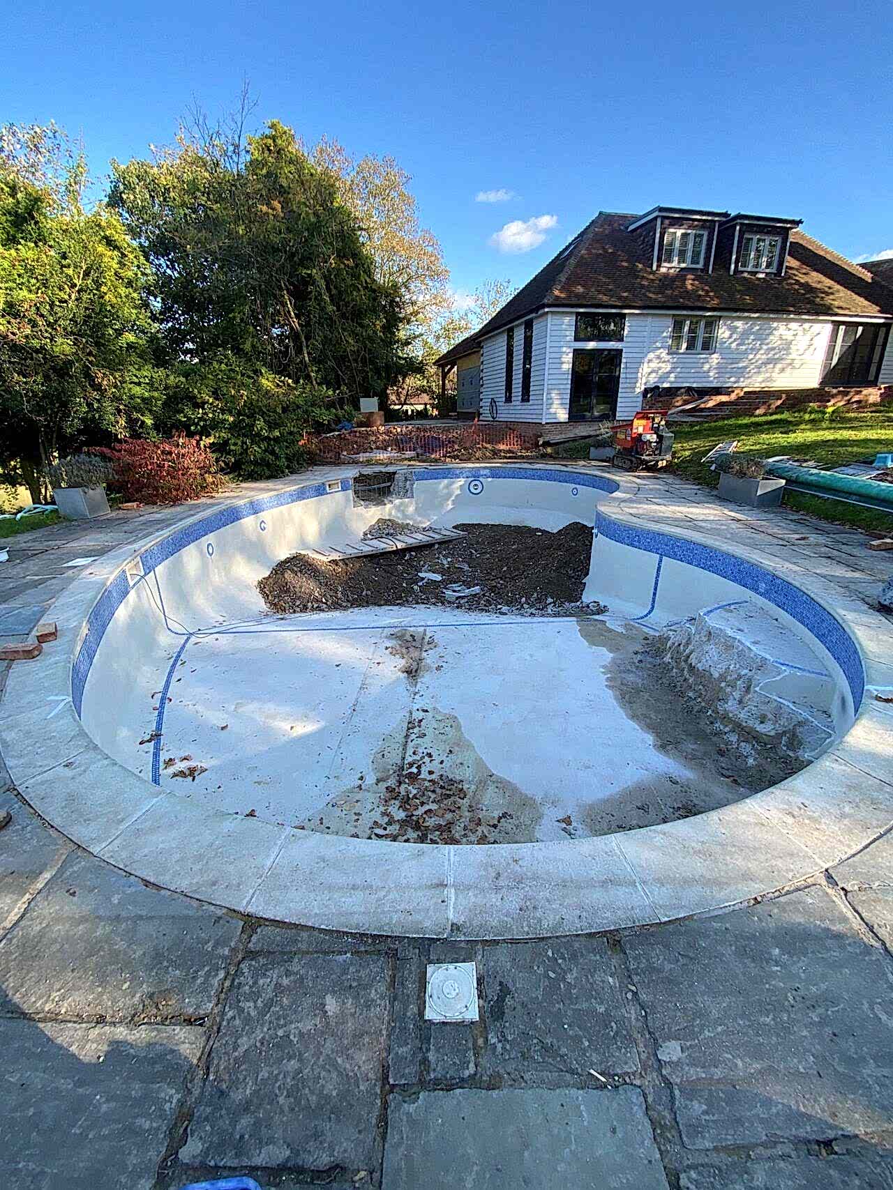 The pool renovation started with draining the old pool and cleaning it first