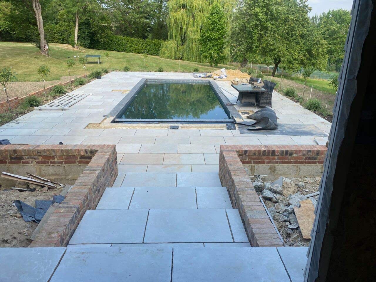 To complement the pool renovation, we installed new paving surrounds