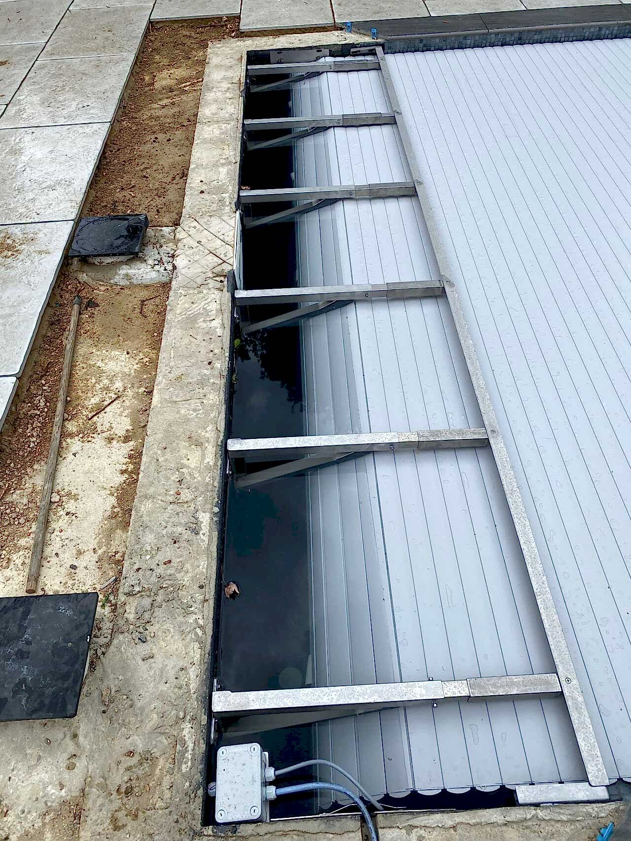 A close-up of the in-ground slatted automatic cover system