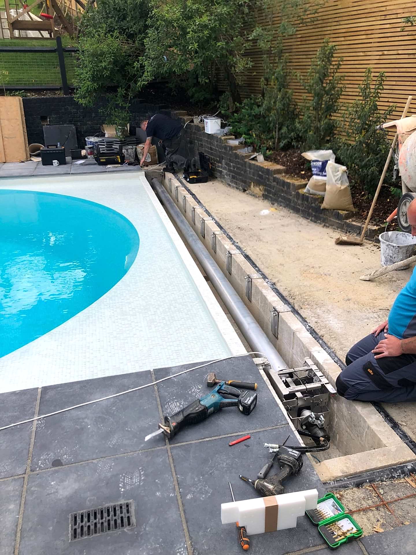 A close-up of the installation of the new pool cover rotary system