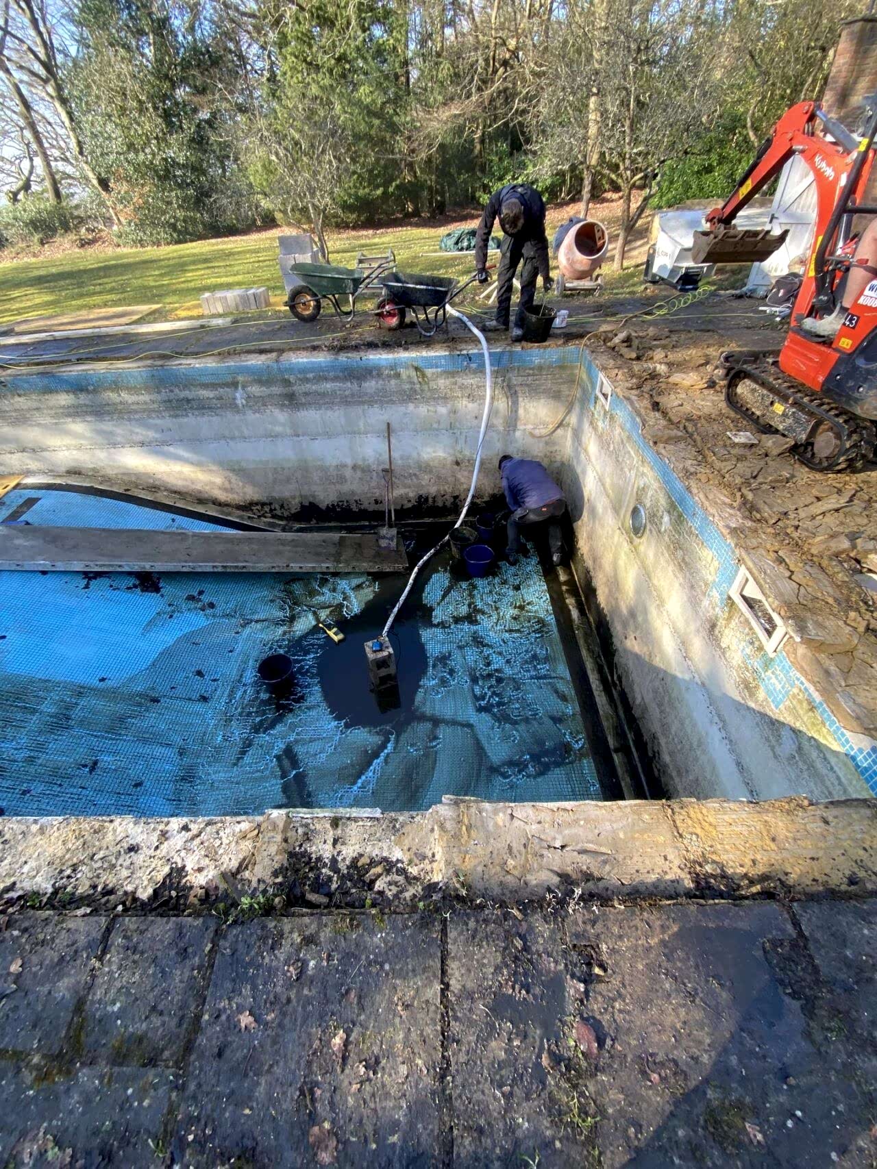 Water being pumped from frost damaged swimming pool