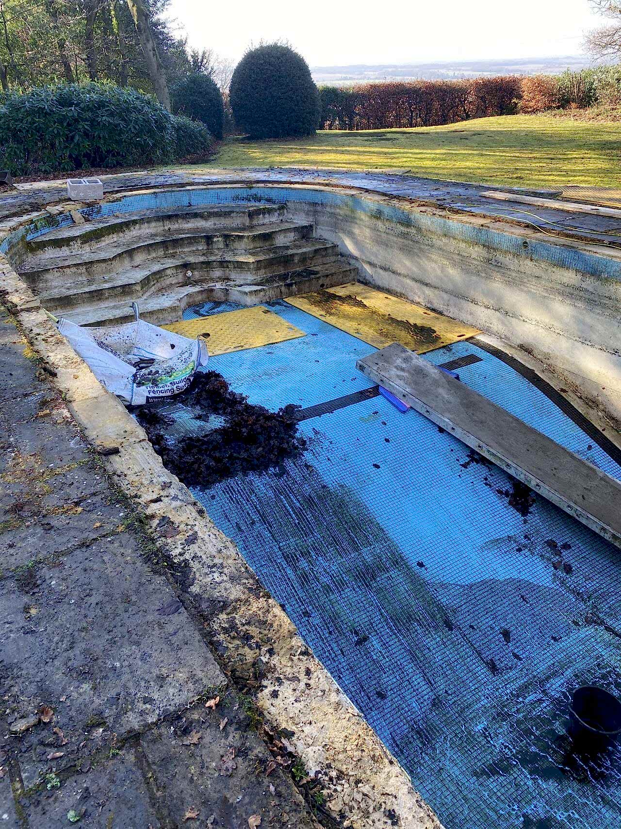 Removal of old swimming pool coping stones ready for swimming pool to be refurbished