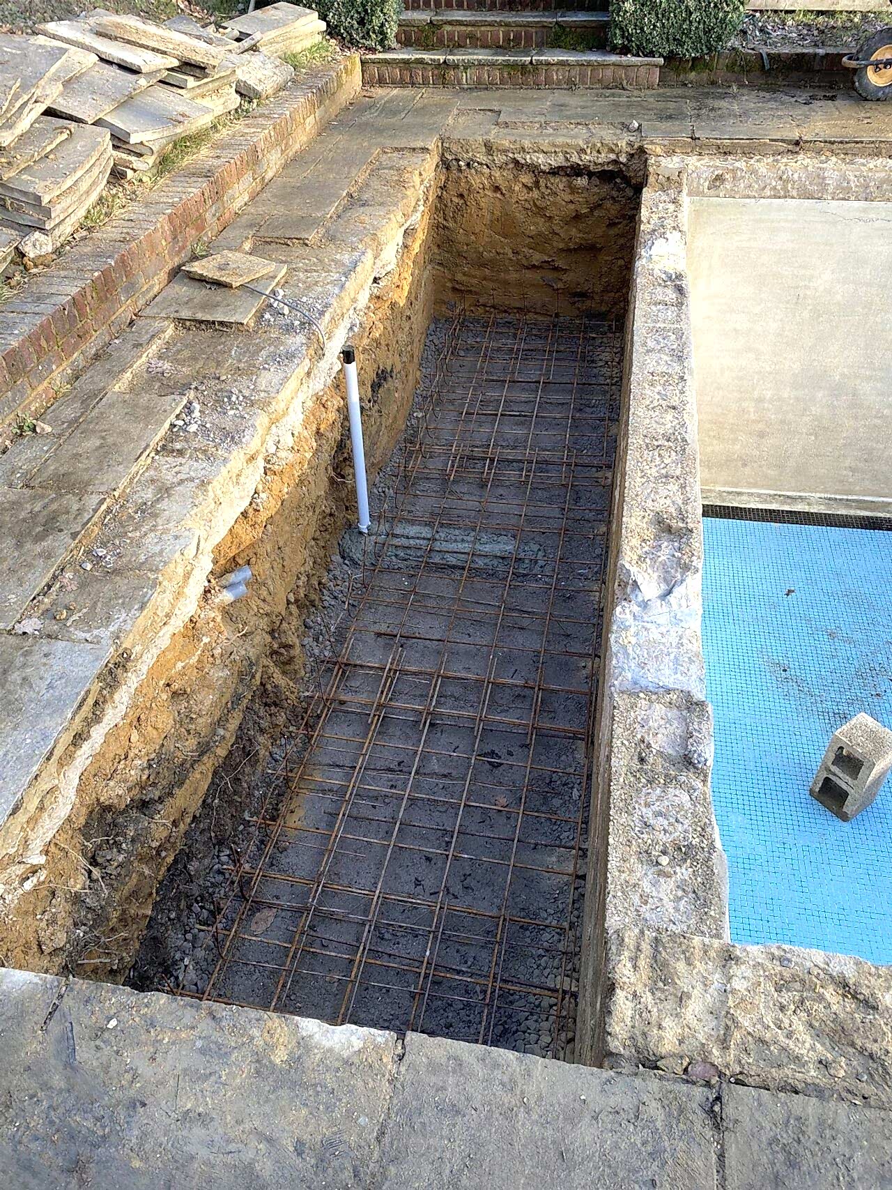 Reinforcement mesh being installed to strengthen the concreted chamber for the automated slatted safety cover
