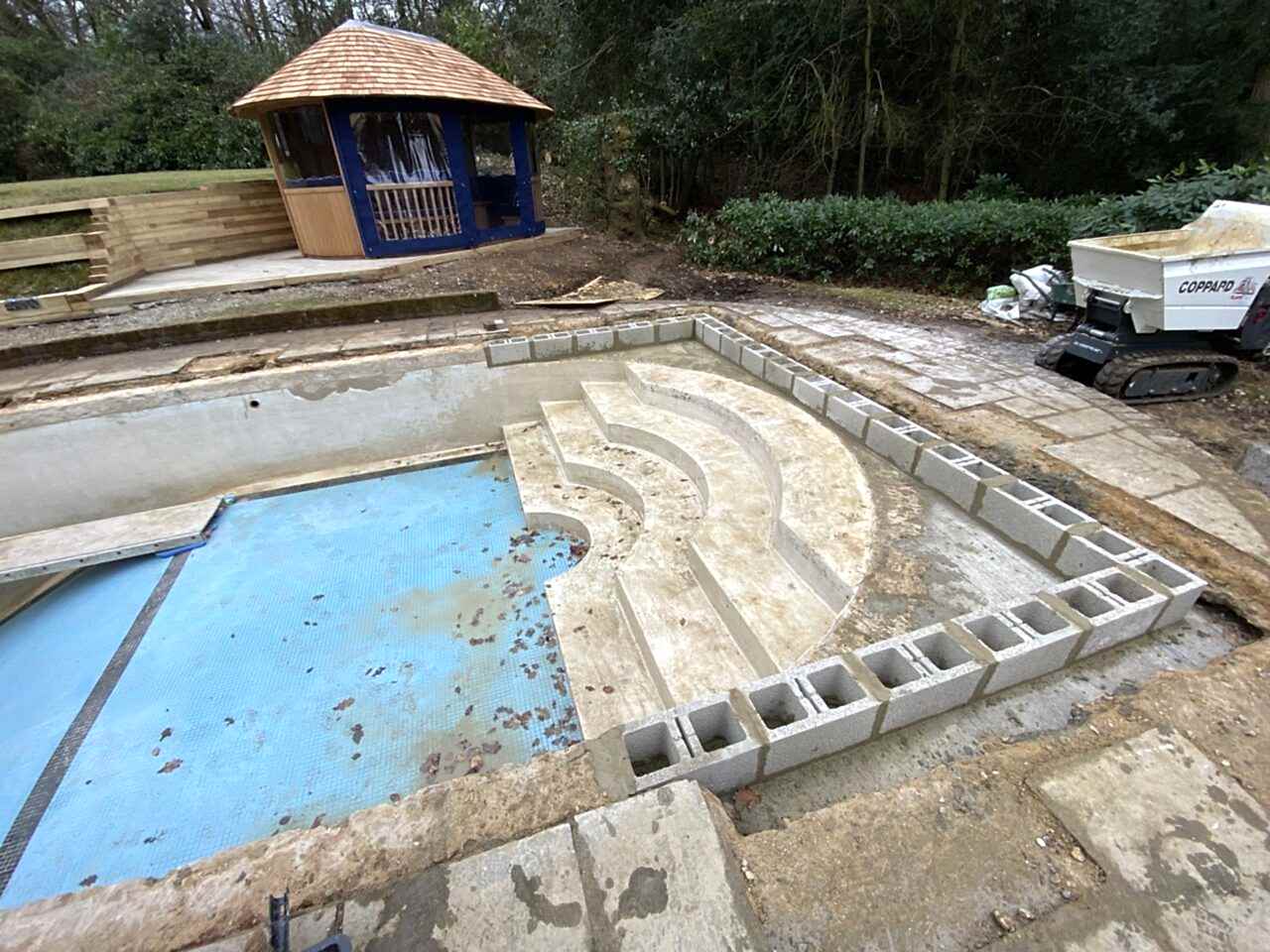 Constructing new straight walled perimeter segments and creating transitional “beached” areas on each side of the steps