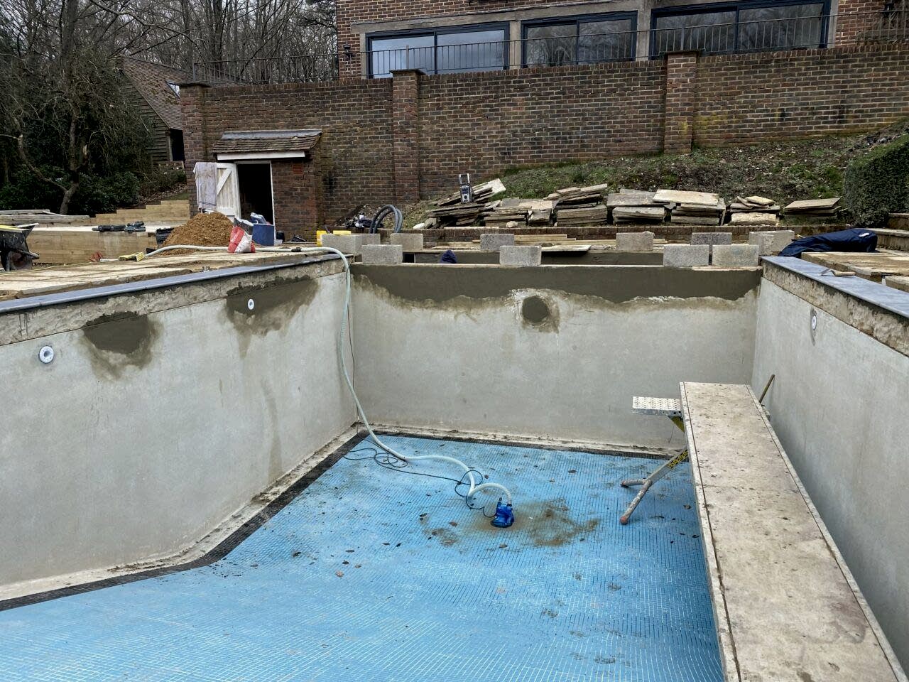 Repairing the swimming pool walls before tiling commences on the refurbishment