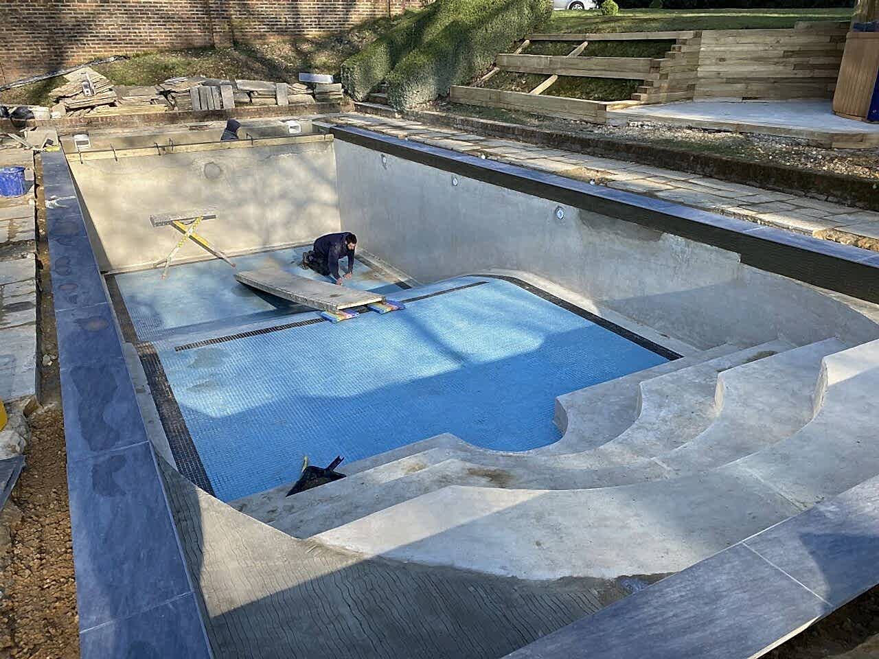 Installing new edging tiles before mosaic tile band