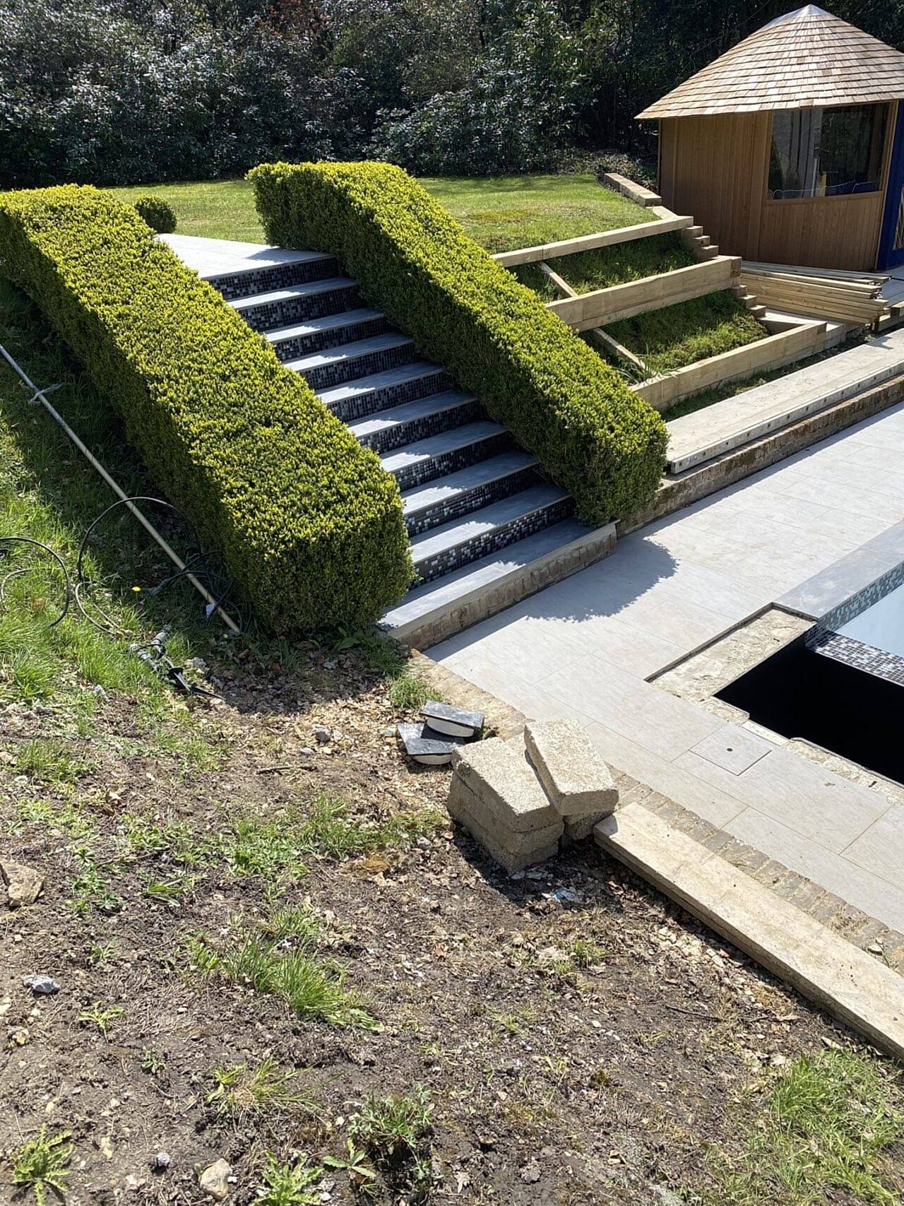 New patio steps leading down to the refurbished swimming pool
