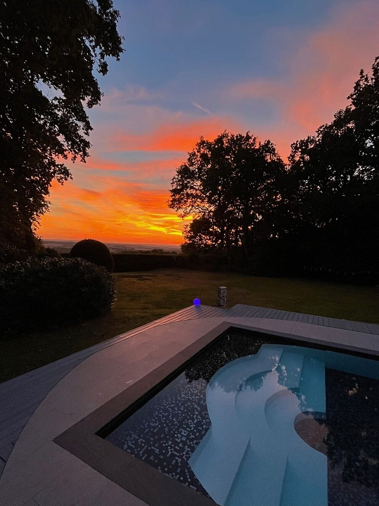 Sunset photo of the newly created steps at the edge of the refurbished swimming pool