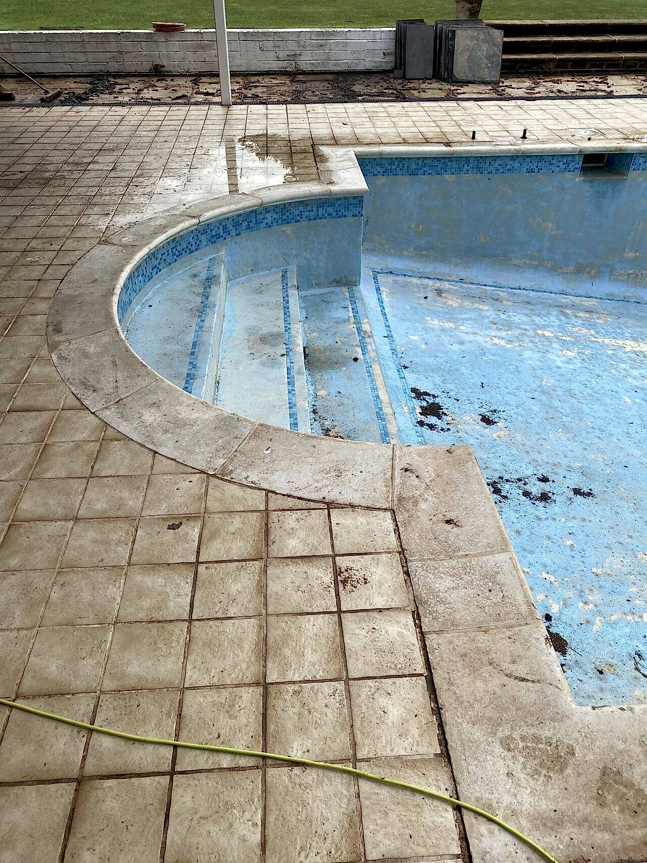 The existing pool featured a large curved stepped end