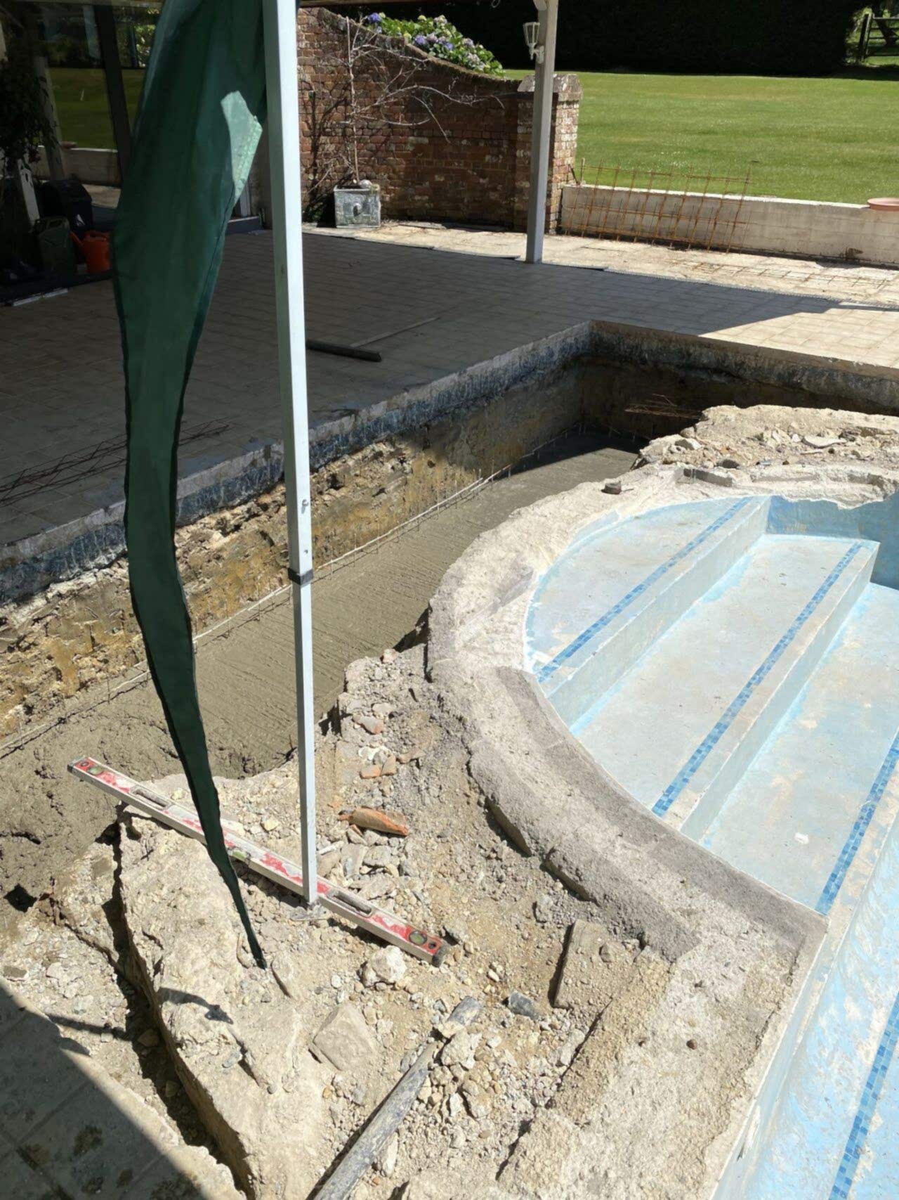 Concrete added to the bottom of the in-ground slatted cover system space for extra strength