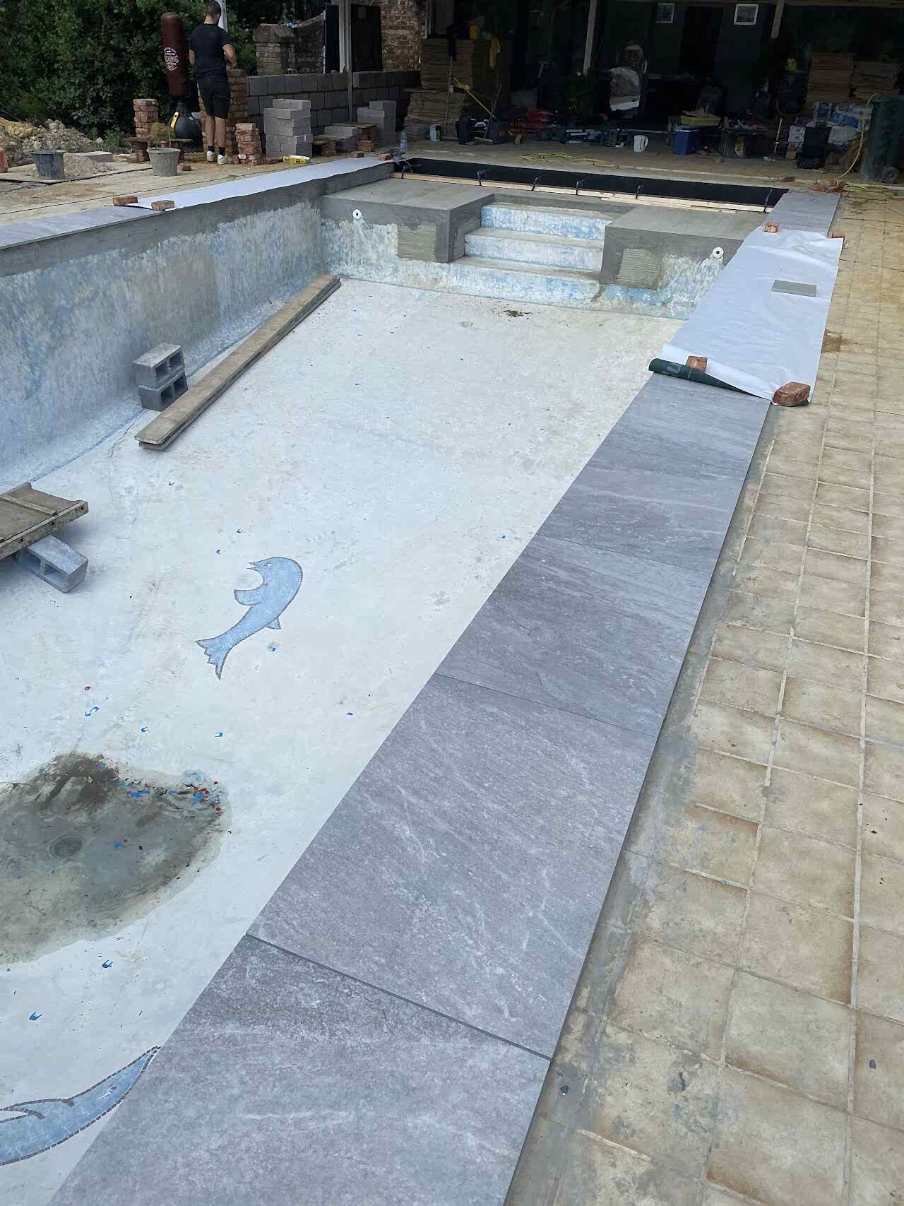 Construction is underway in and around the swimming pool
