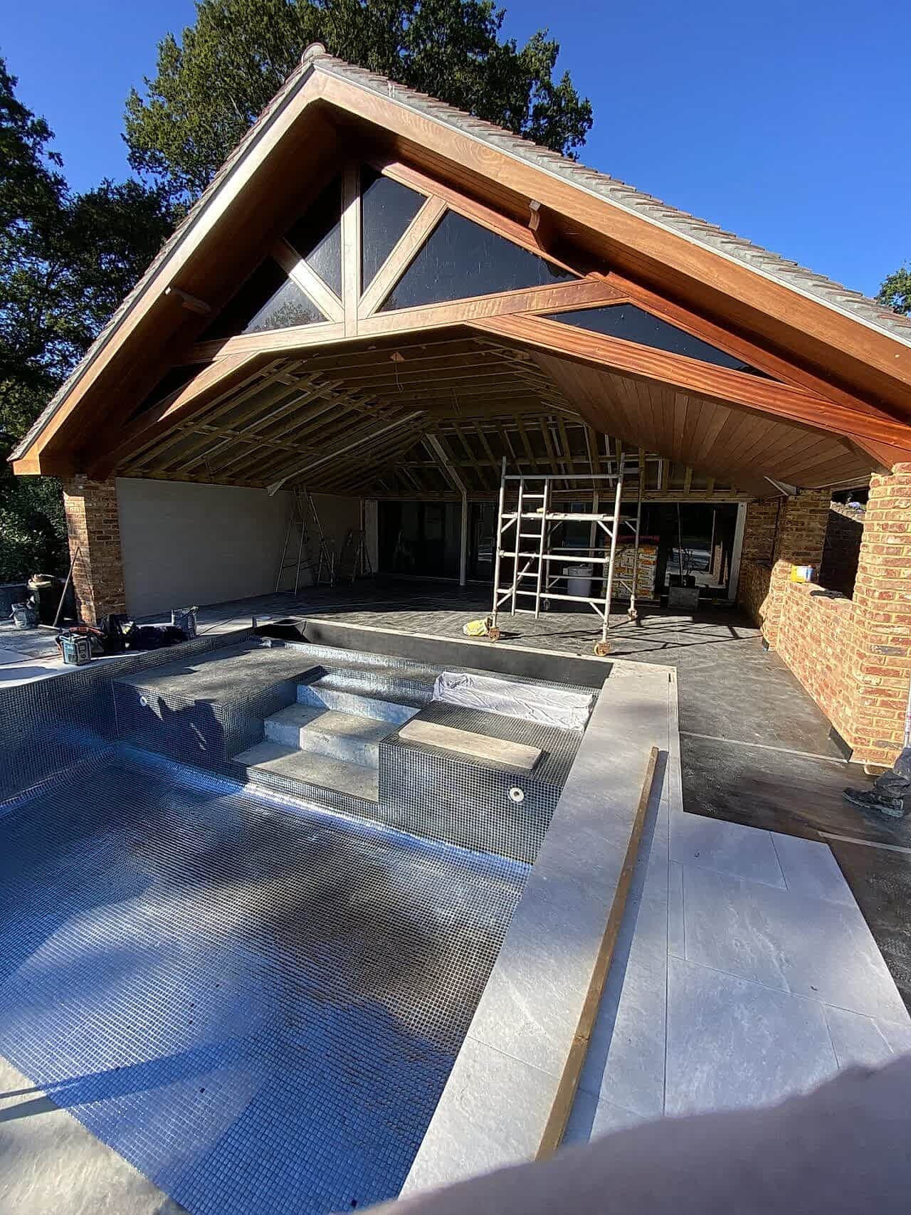 The bottom of the swimming pool is getting tiled - starting from the side of the entrance to the pool