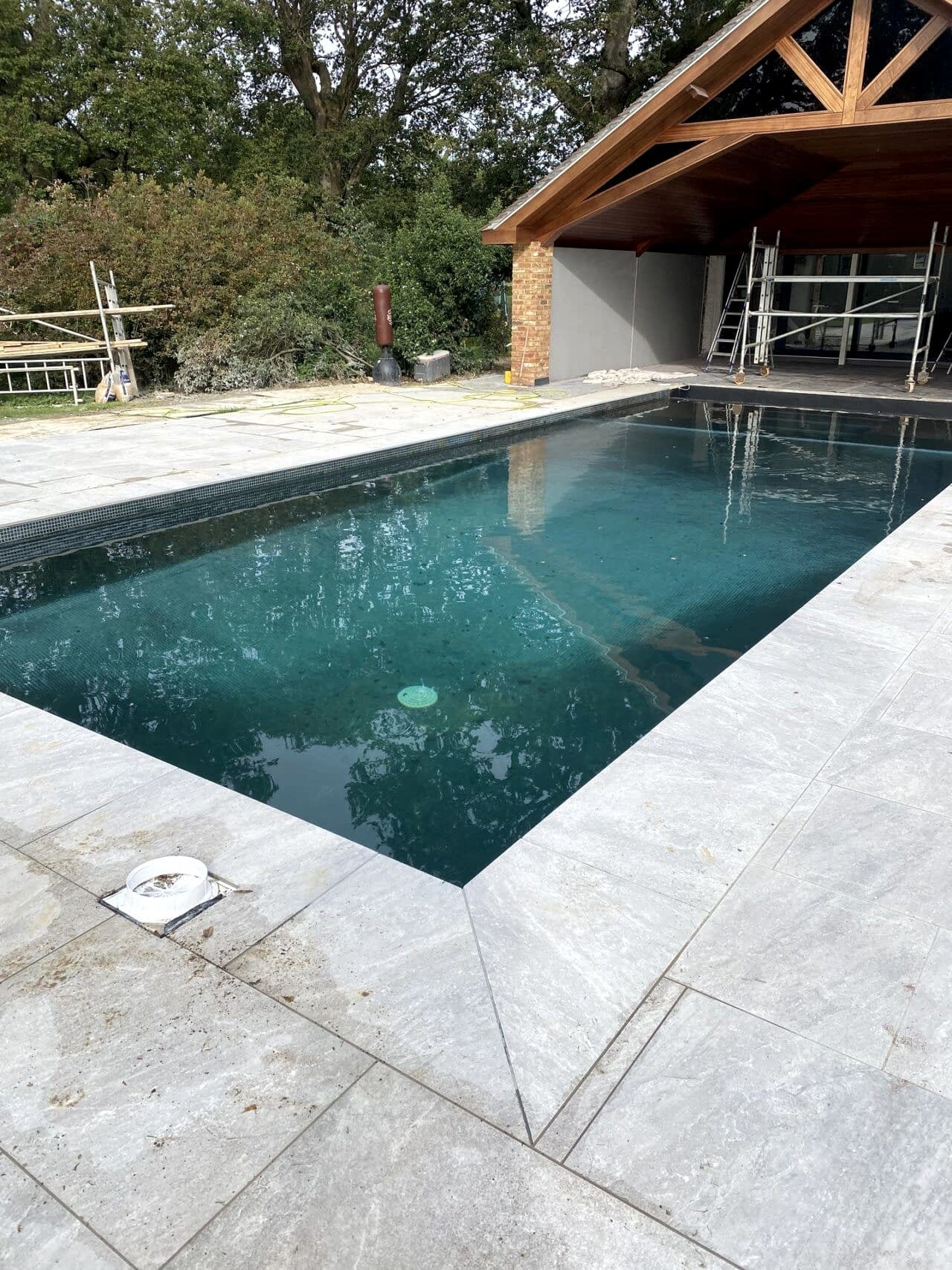 After the swimming pool is done, we replaced the surrounding paving