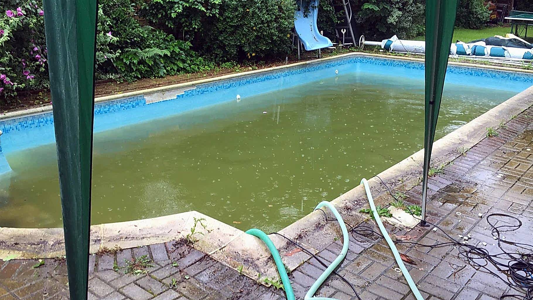 Tired swimming pool with damaged tiling