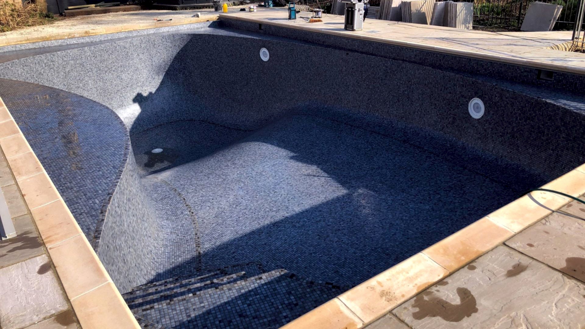 Outdoor swimming pool after reshaping and refurbishment