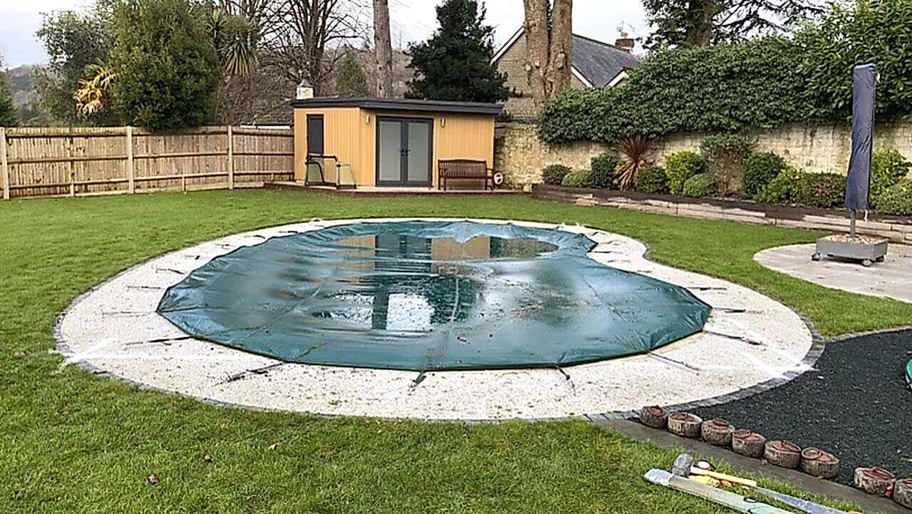 A manual pool cover over the original swimming pool