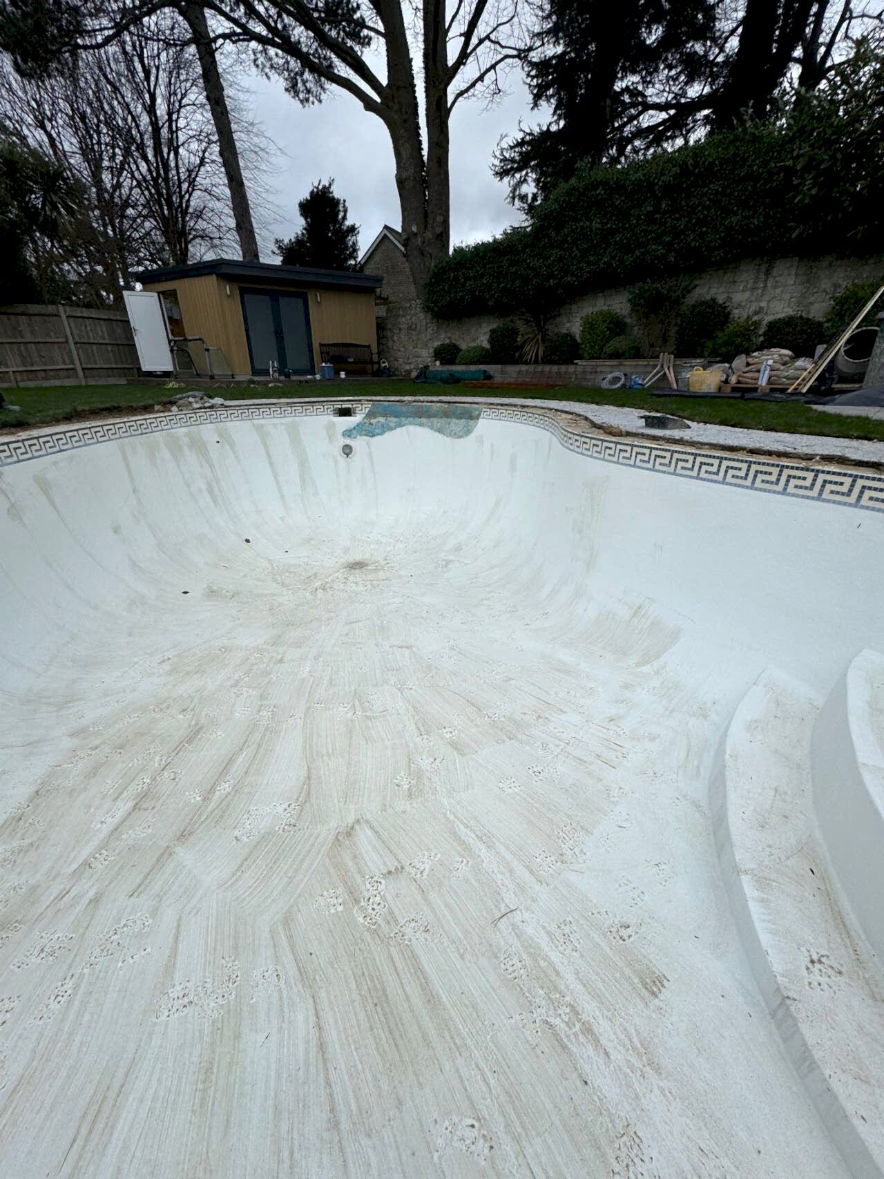 The old pool has been emptied and cleaned before retiling