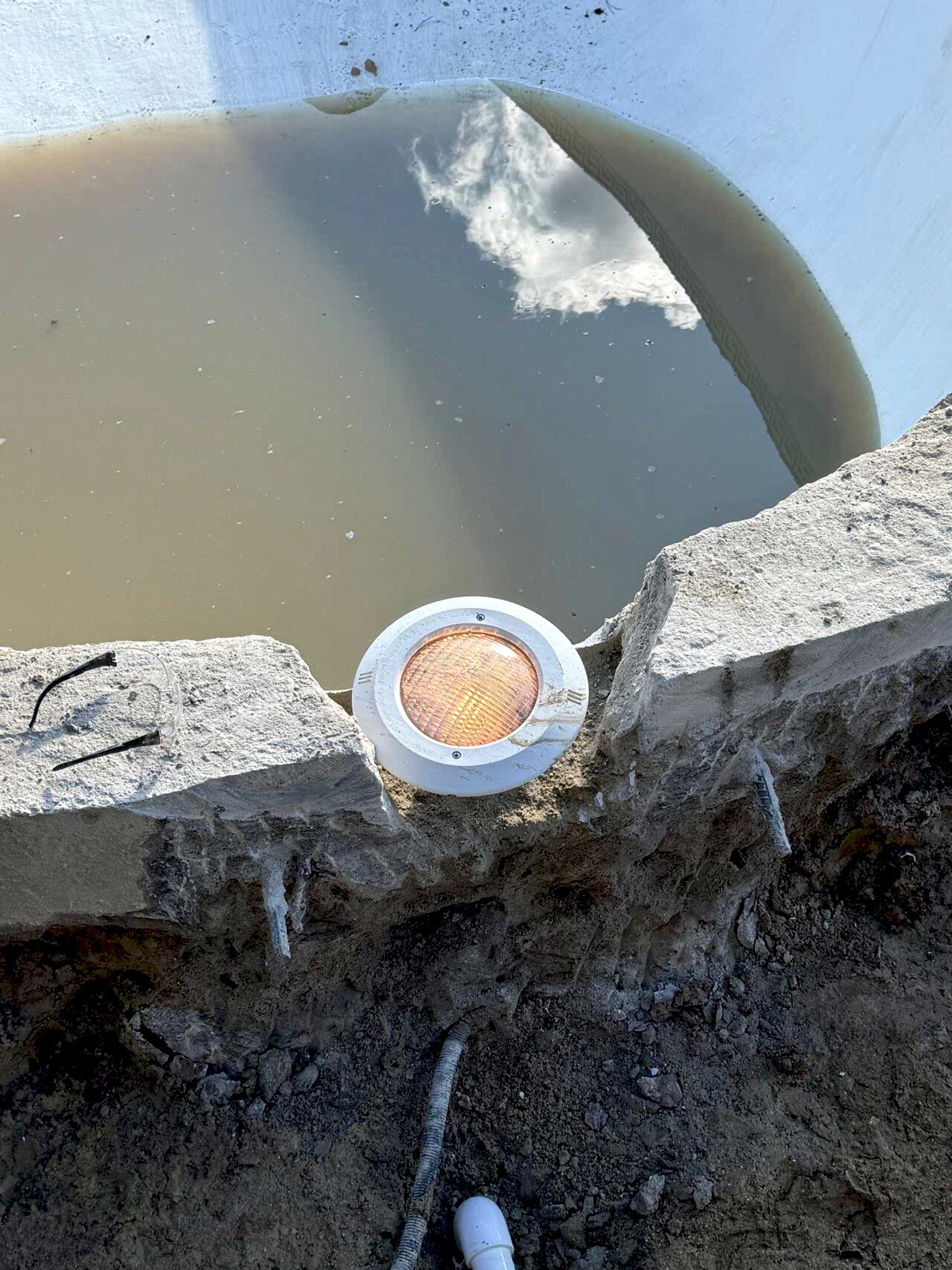 Close-up of a light component on the edge of the swimming pool