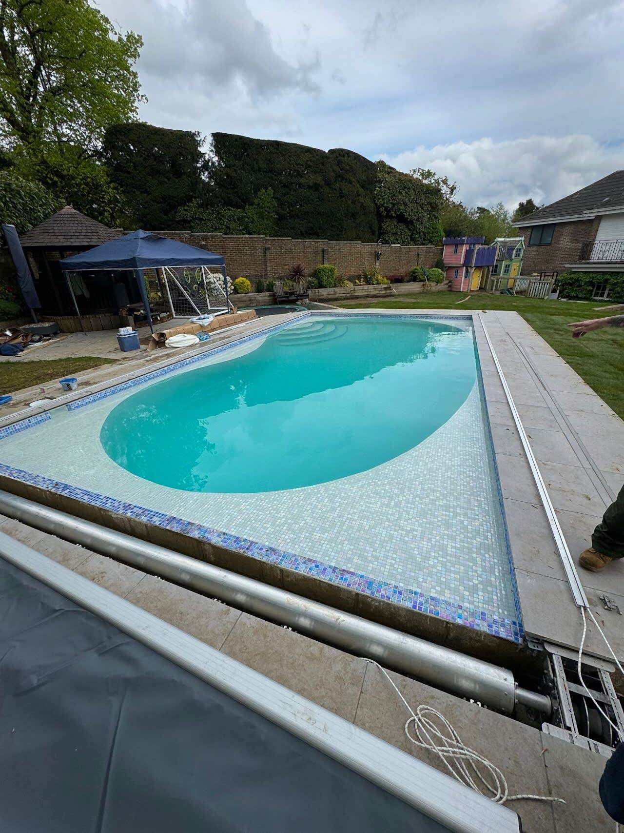 Pavings are being installed around the pool and over the automatic swimming pool cover