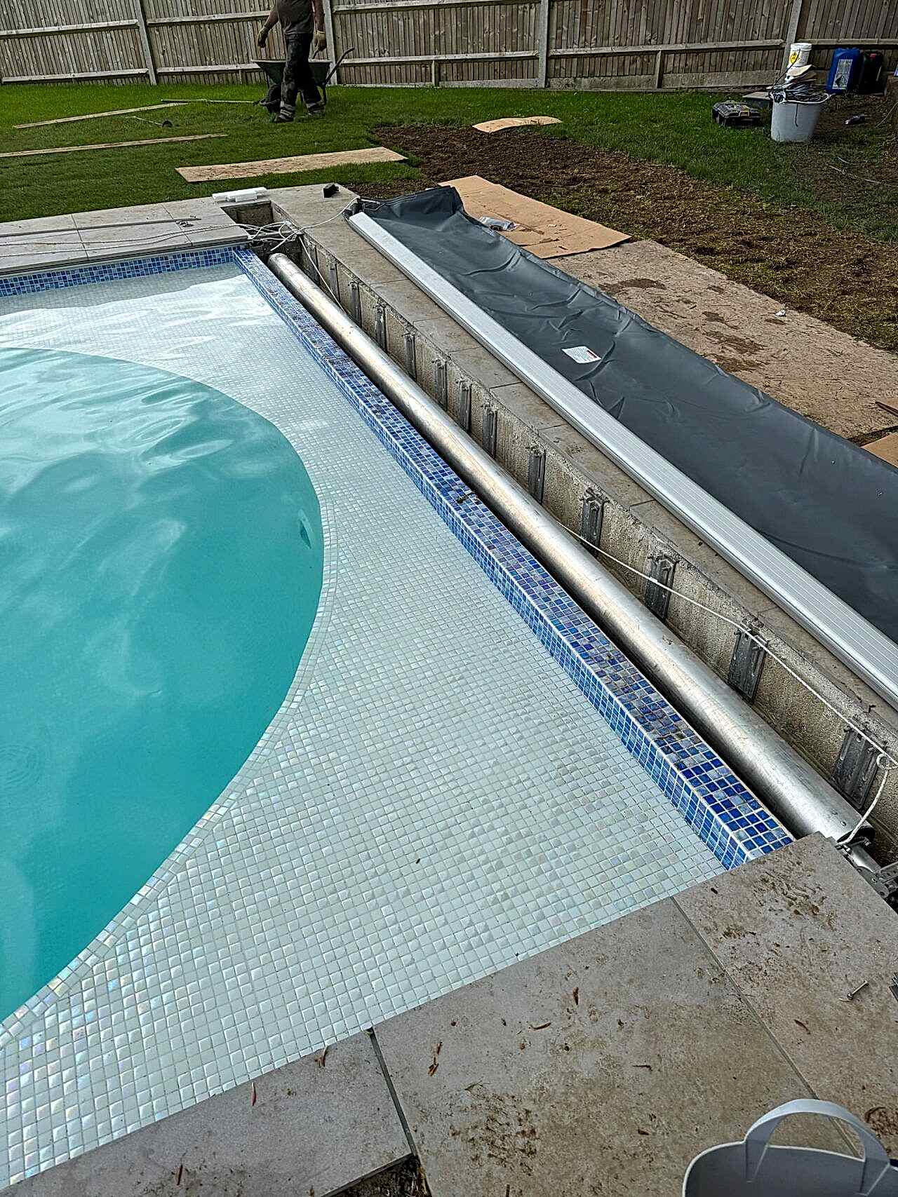 The automatic swimming pool cover system before covered