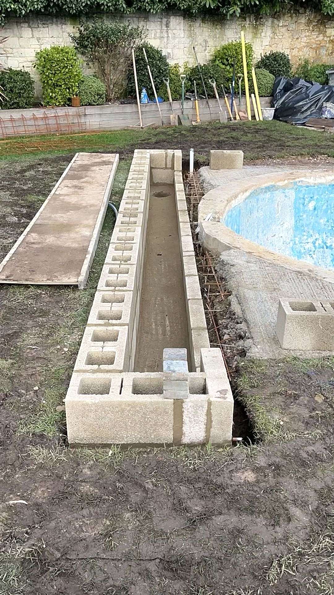 The storage place for the automatic pool cover is nearly finished