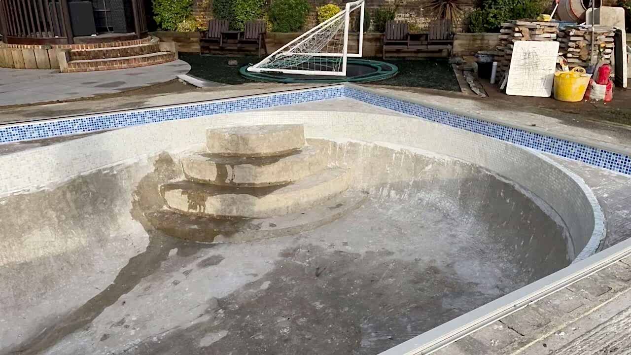 Angle view of the swimming pool steps before the new tiles installed